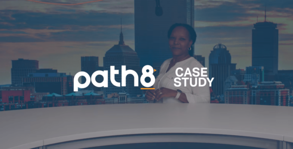 A person stands behind a white desk with a city skyline and evening sky in the background. The text reads: "path8 CASE STUDY.